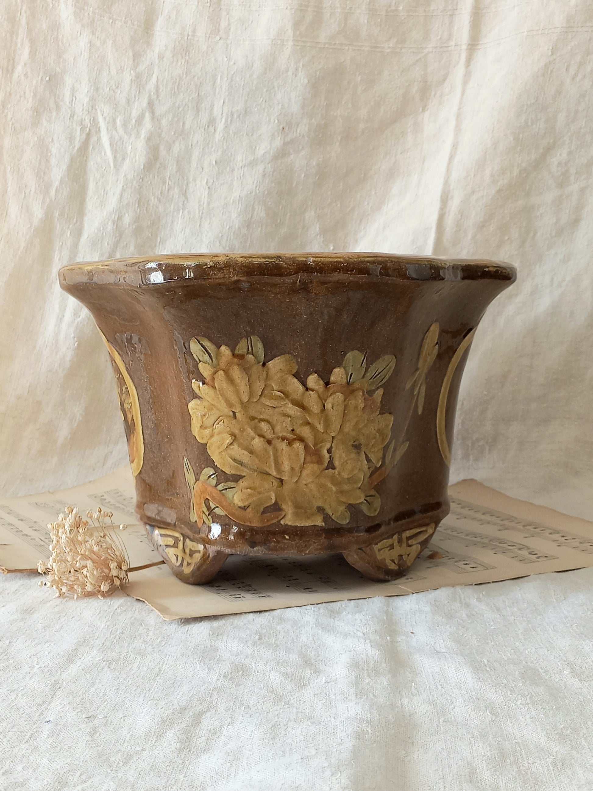 A stunning decorative glazed stoneware planter with oriental animal and floral design influences. 