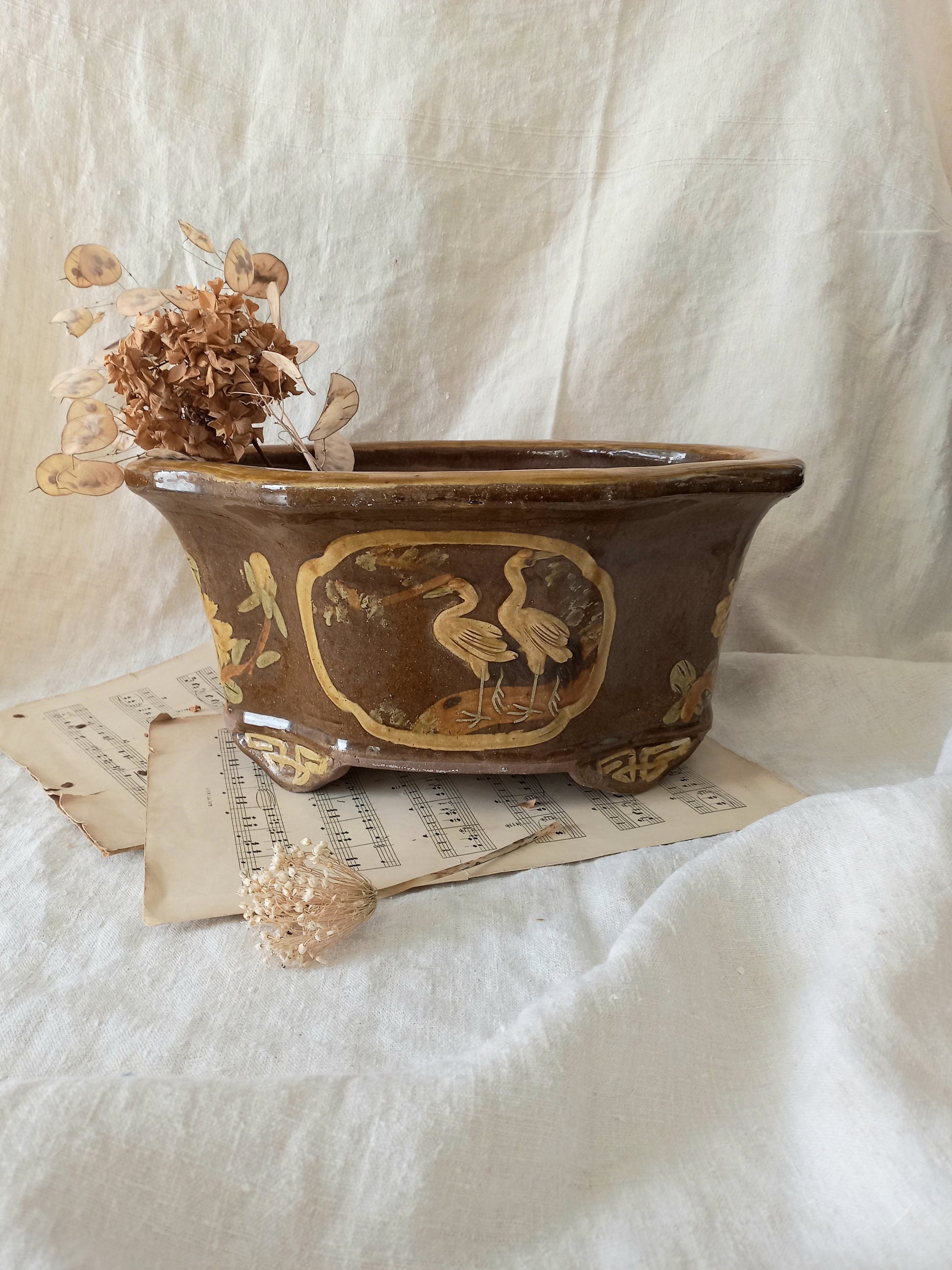 A stunning decorative glazed stoneware planter with oriental animal and floral design influences. 