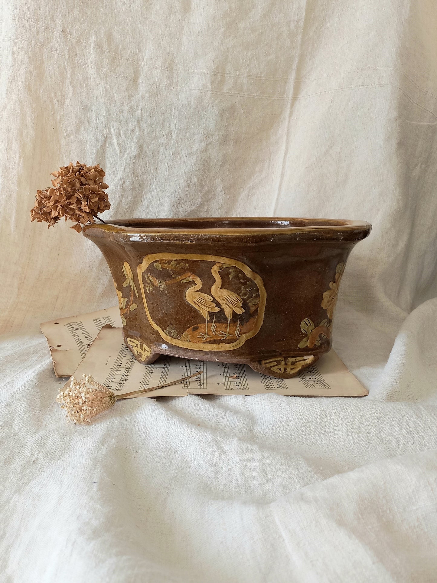 A stunning decorative glazed stoneware planter with oriental animal and floral design influences. 