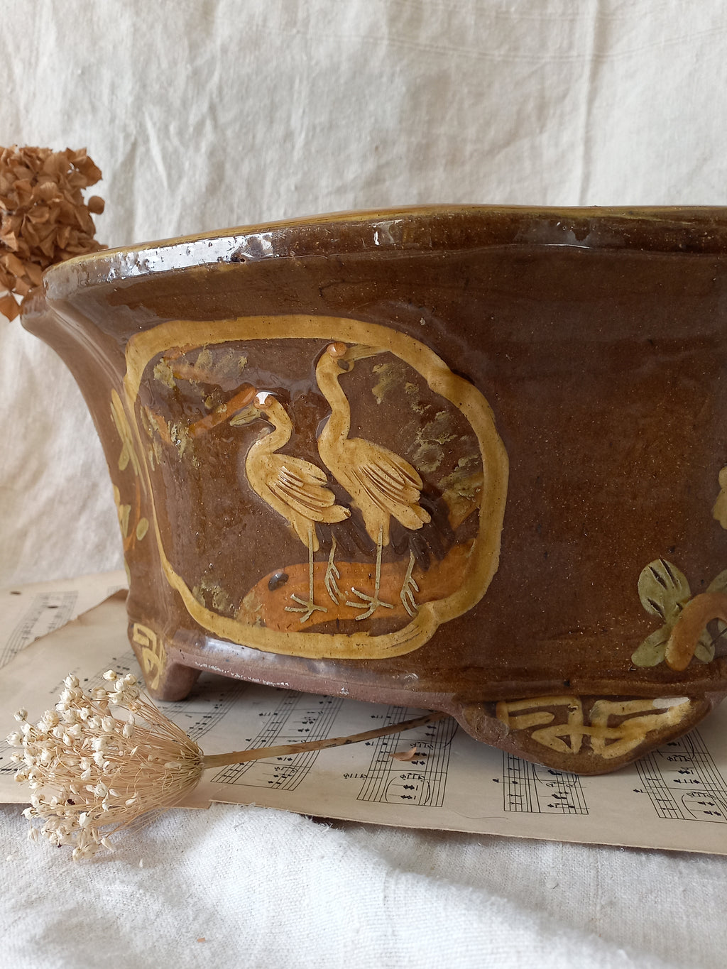 A stunning decorative glazed stoneware planter with oriental animal and floral design influences. 