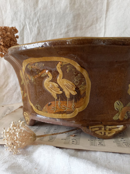 A stunning decorative glazed stoneware planter with oriental animal and floral design influences. 