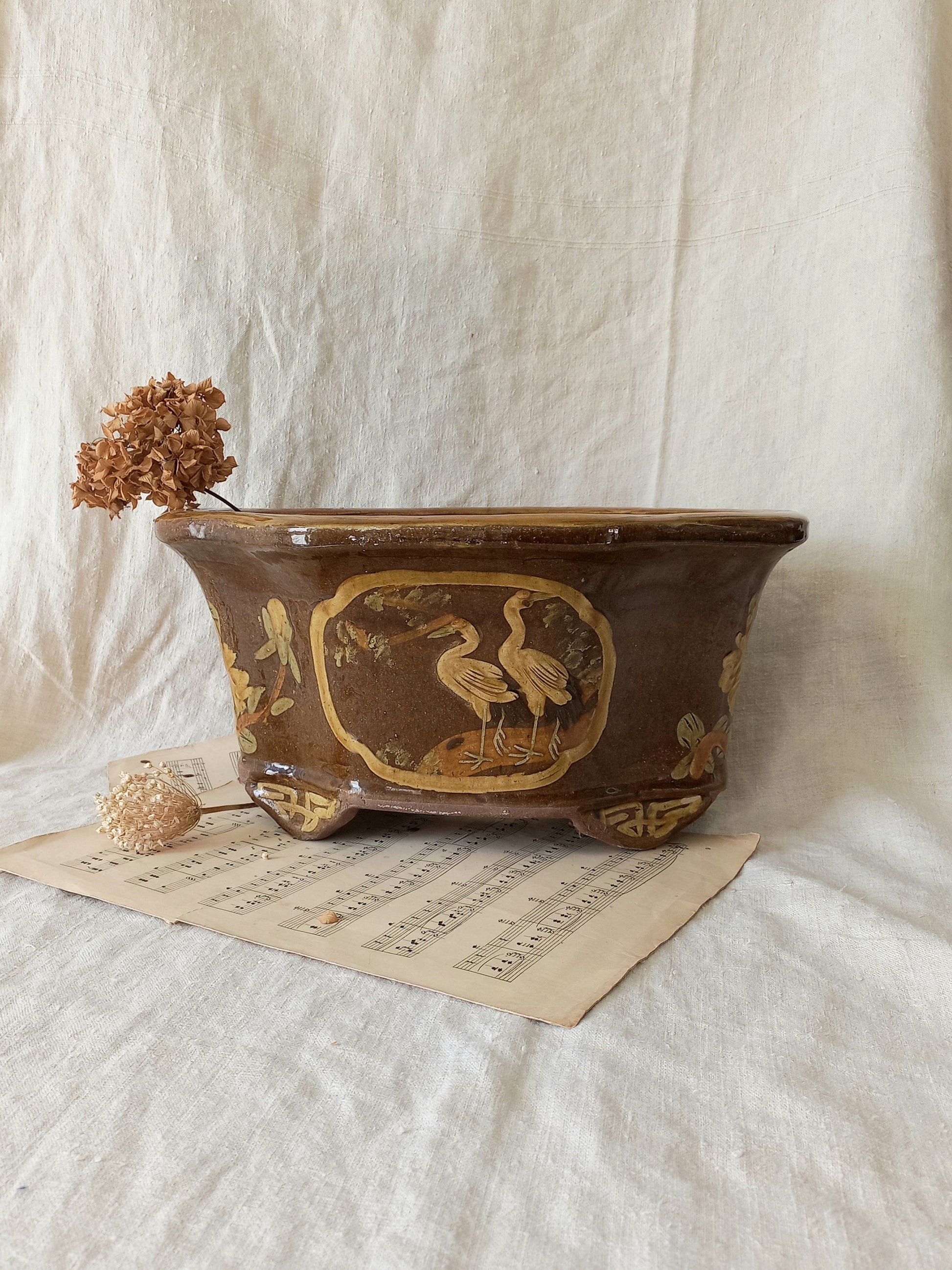 A stunning decorative glazed stoneware planter with oriental animal and floral design influences. 