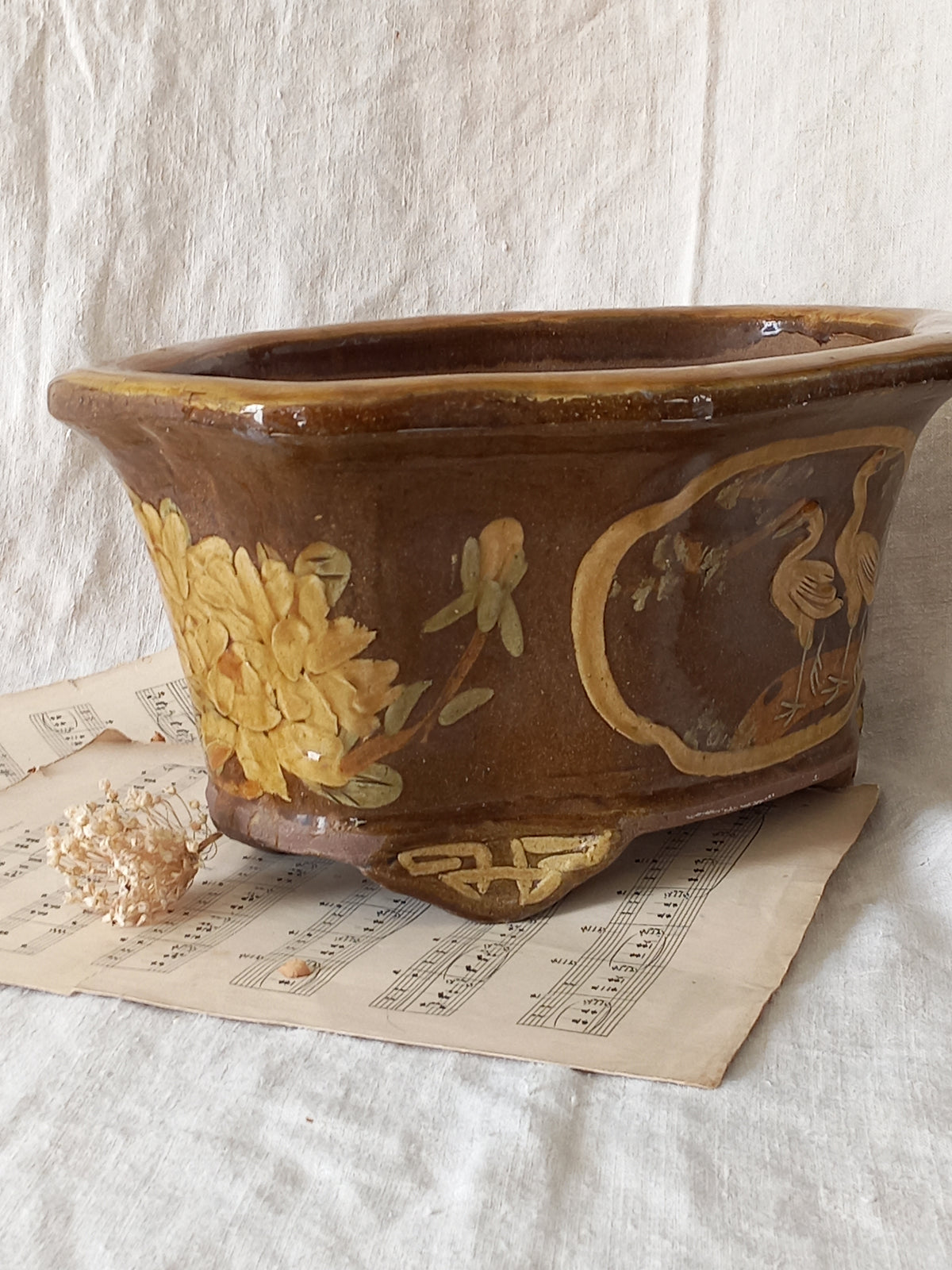 A stunning decorative glazed stoneware planter with oriental animal and floral design influences. 