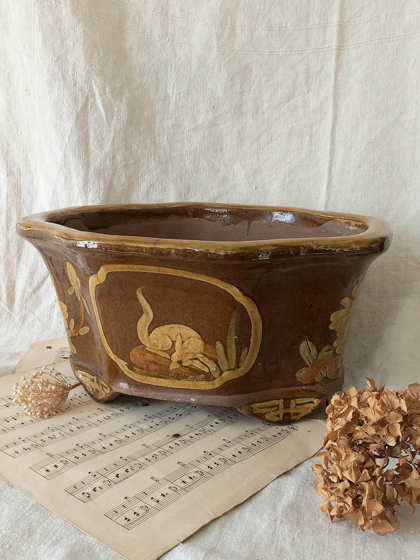 A stunning decorative glazed stoneware planter with oriental animal and floral design influences. 