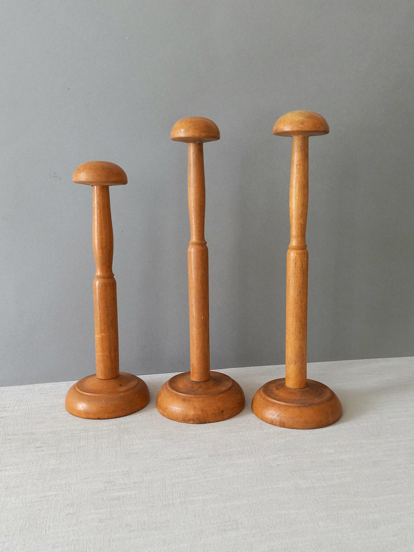 Three vintage wooden hat stands
