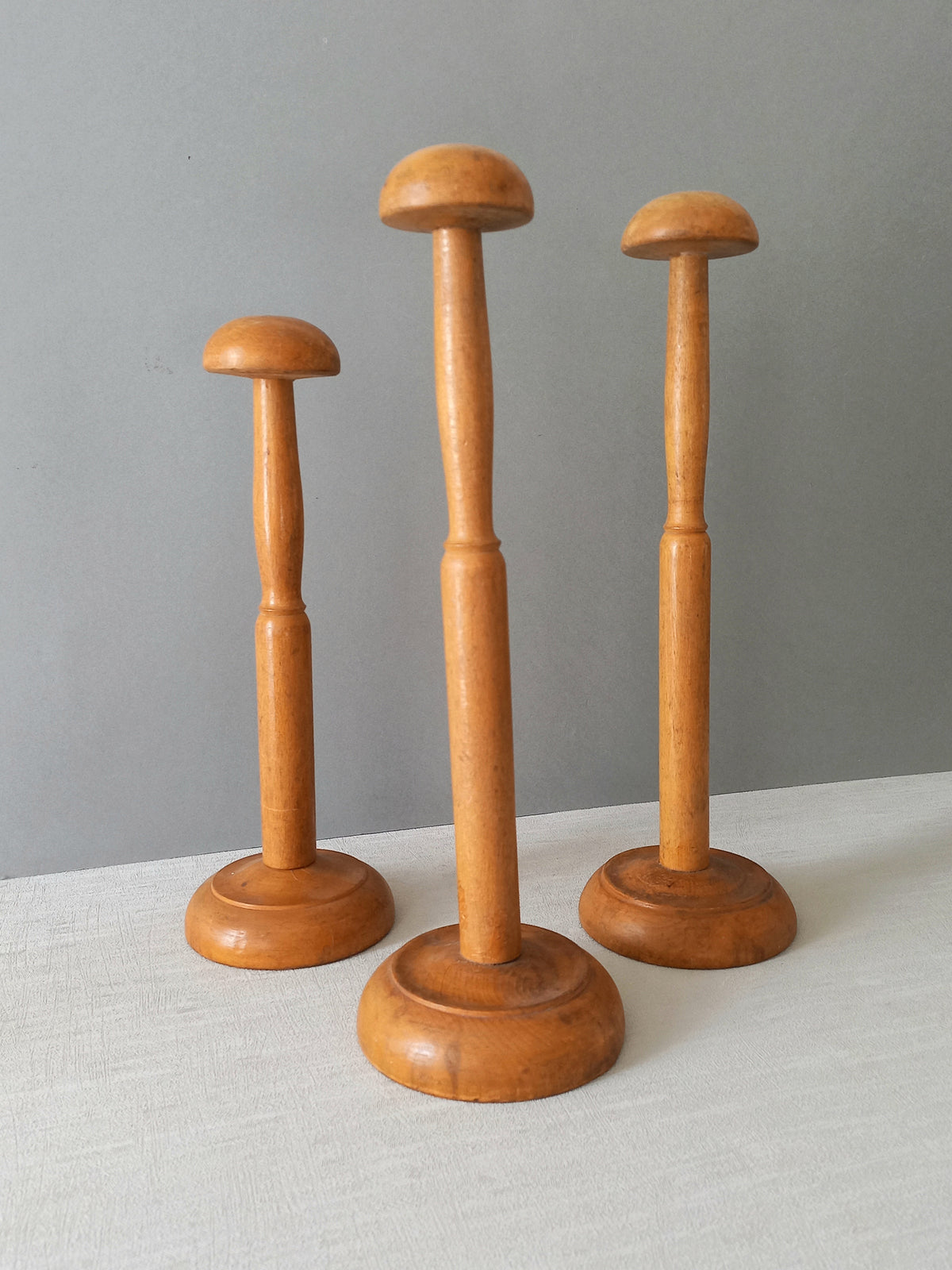 Three vintage wooden hat stands