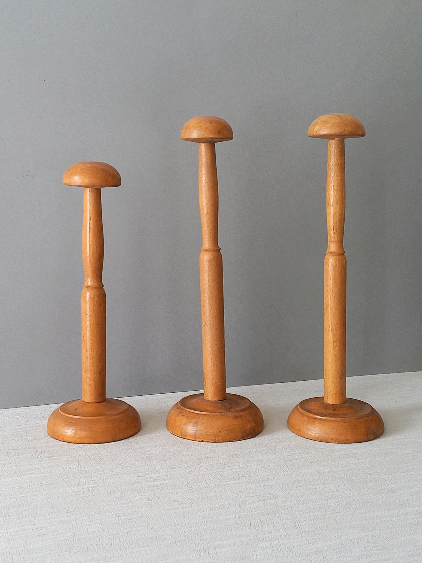 Three vintage wooden hat stands