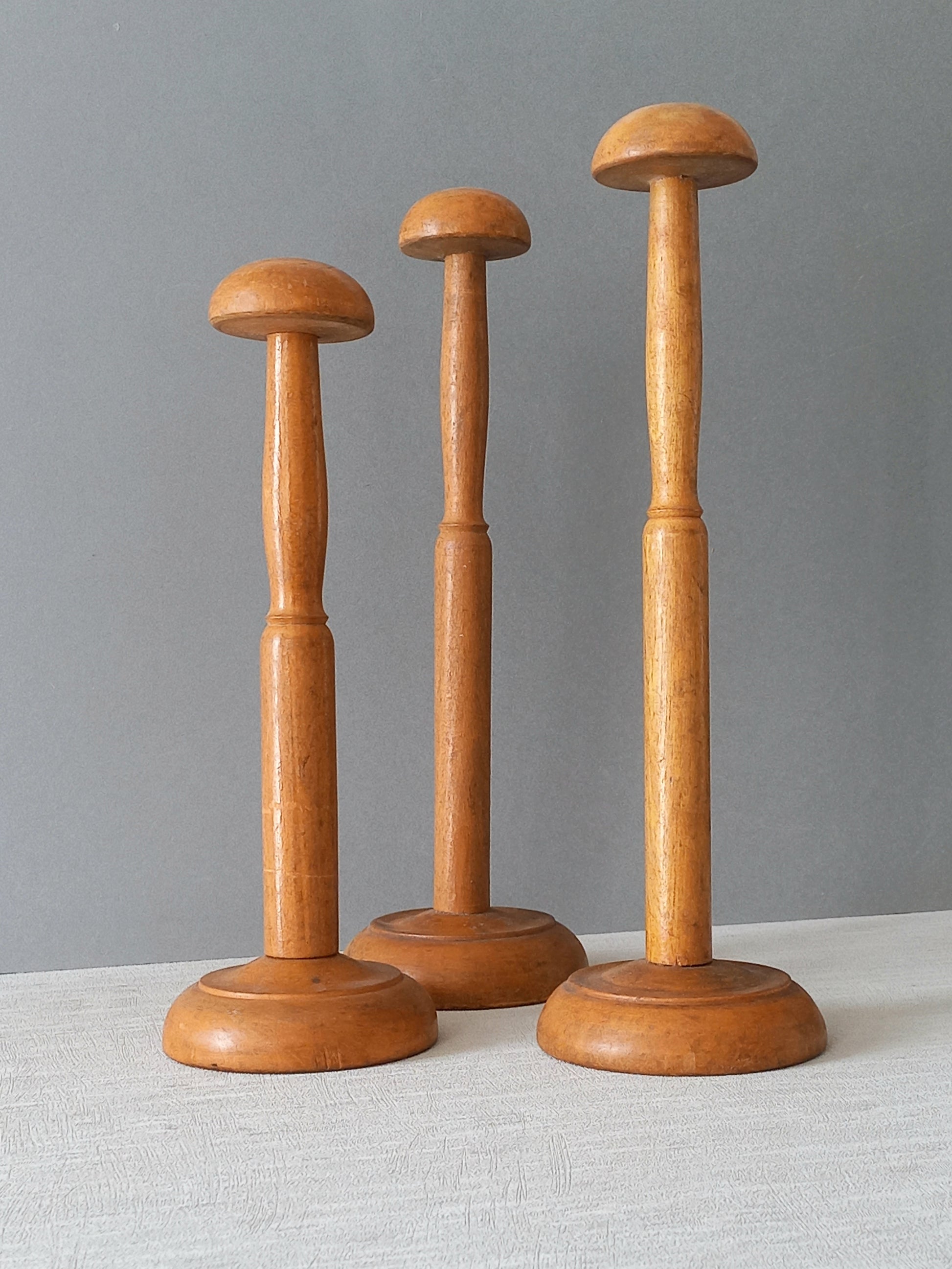 Three vintage wooden hat stands