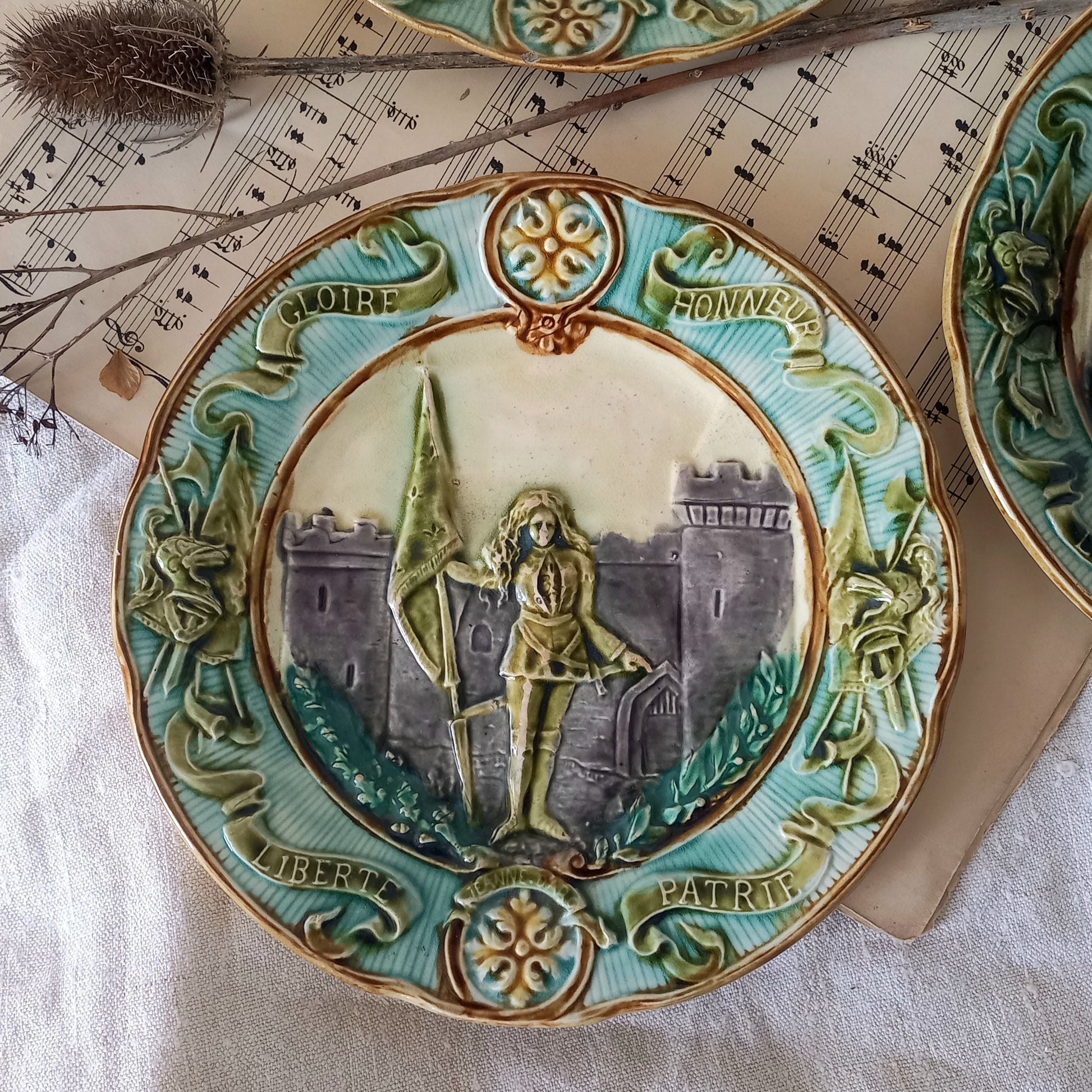 Decorative ceramic plate with artistic design on a textured surface