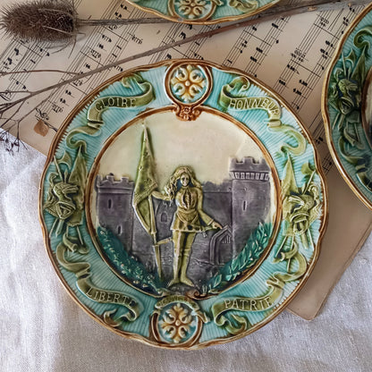 Decorative ceramic plate with artistic design on a textured surface