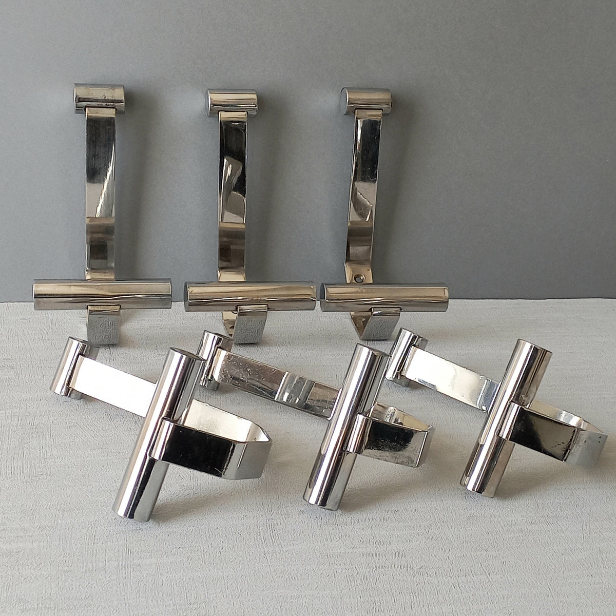 Set of 6 French vintage mid-century coat and hat hooks made from polished metal that can be simply fitted to your wall using the mounting holes.