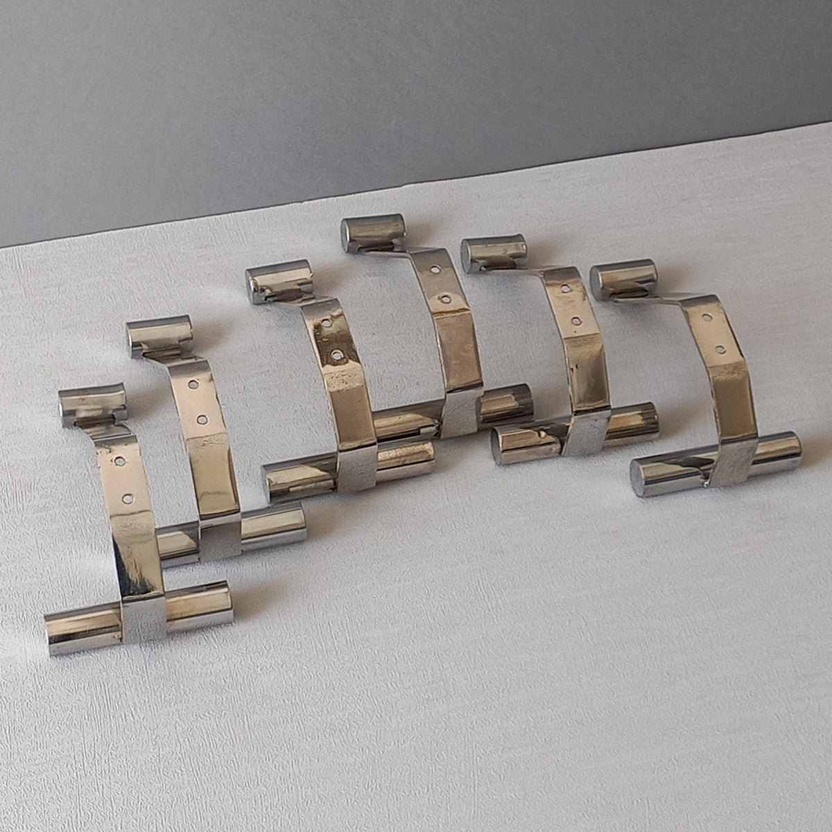 Set of 6 French vintage mid-century coat and hat hooks made from polished metal that can be simply fitted to your wall using the mounting holes.
