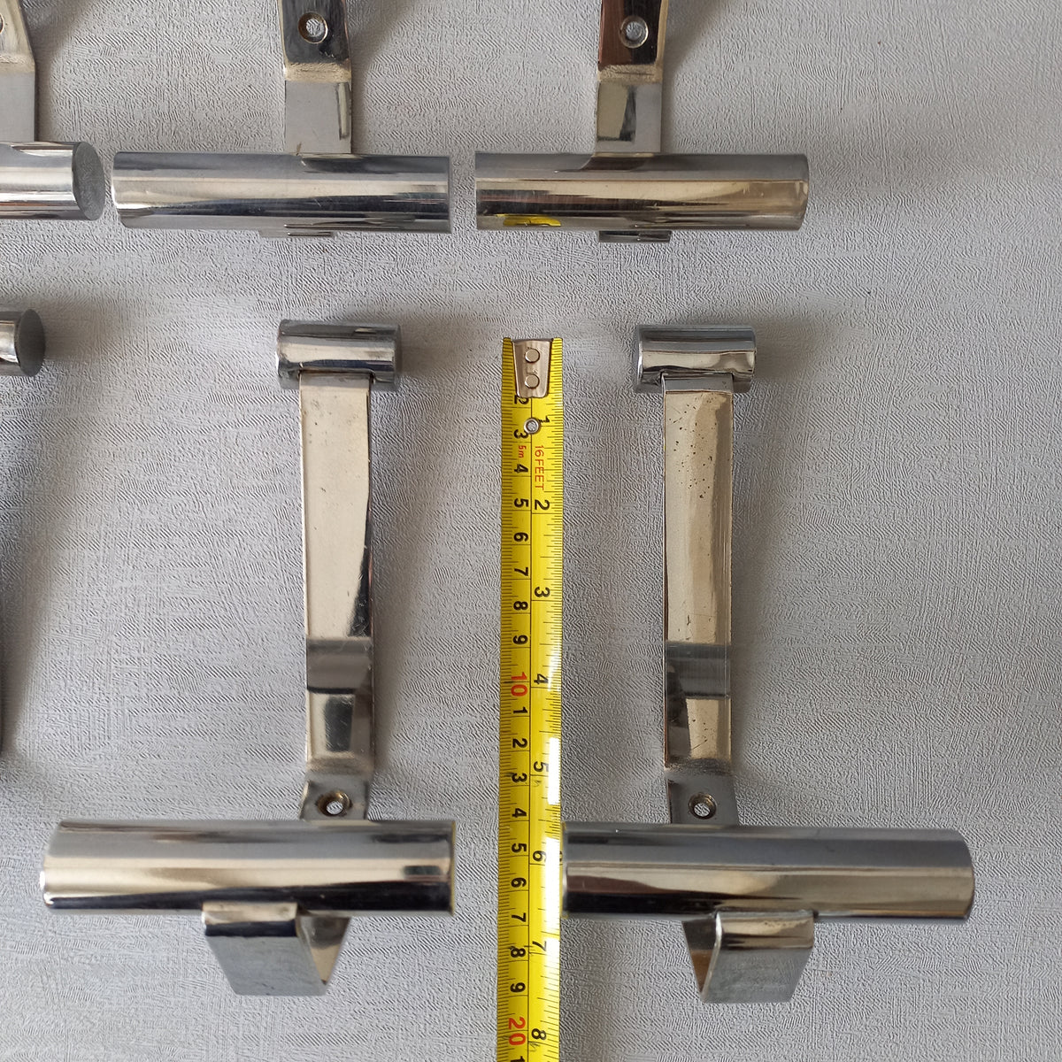 Set of 6 French vintage mid-century coat and hat hooks made from polished metal that can be simply fitted to your wall using the mounting holes.
