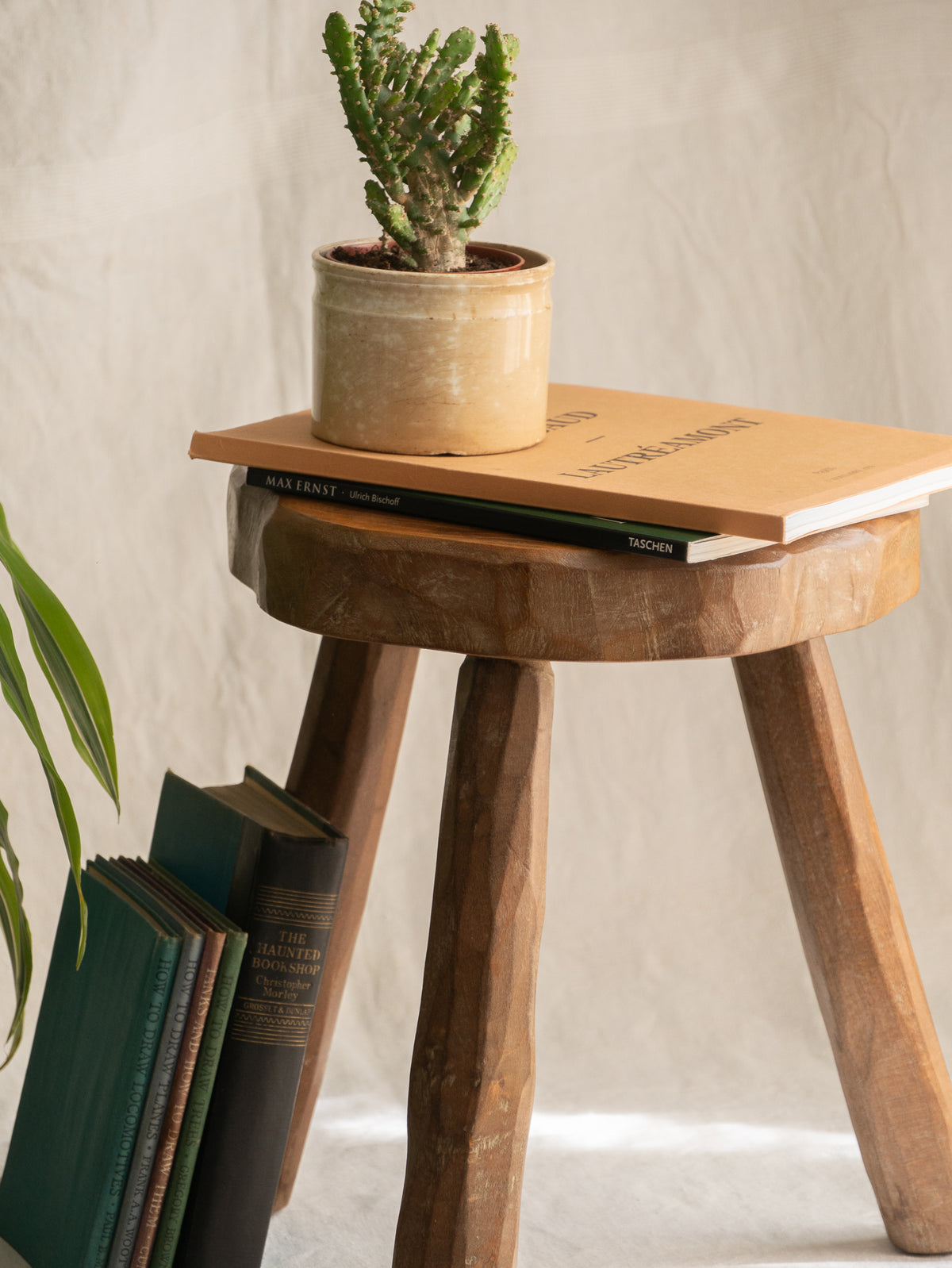 A French vintage chunky three legged wooden stool, a rustic piece with a lovely thick wooden seat that shows the natural pattern of the wood beautifully.