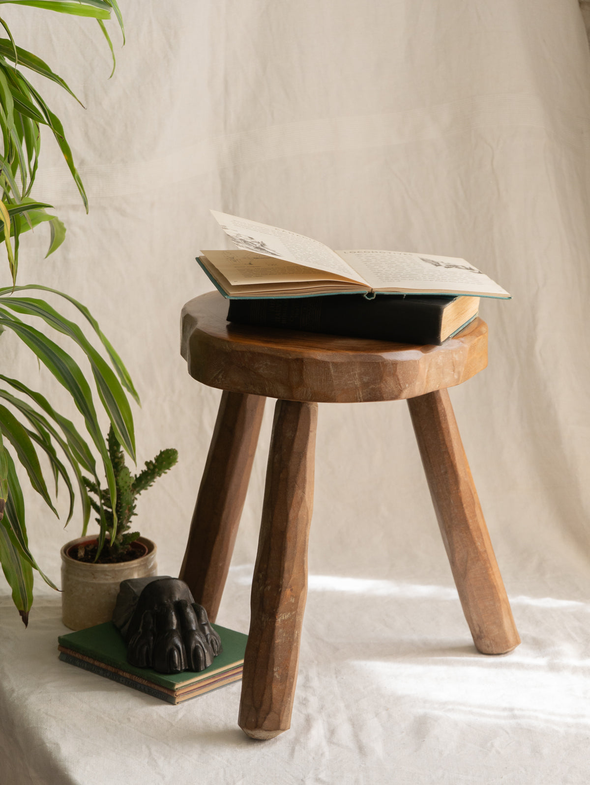 A French vintage chunky three legged wooden stool, a rustic piece with a lovely thick wooden seat that shows the natural pattern of the wood beautifully.