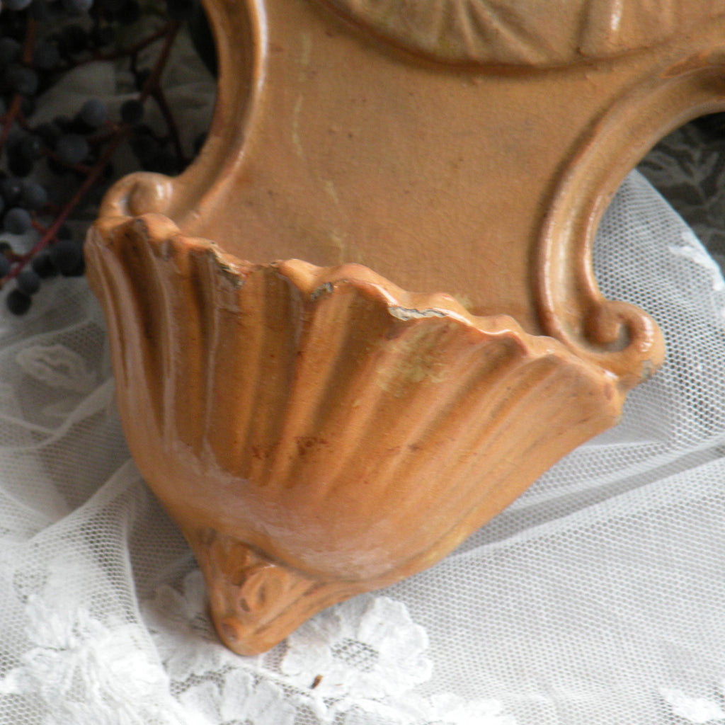 Close-up of French antique glazed stoneware Holy Water font/stoup with Jesus Christ in relief.
