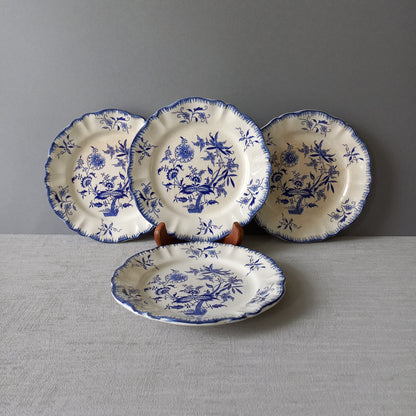 A stunning set of 4 small antique white ironstone plates with blue floral patterns from France.