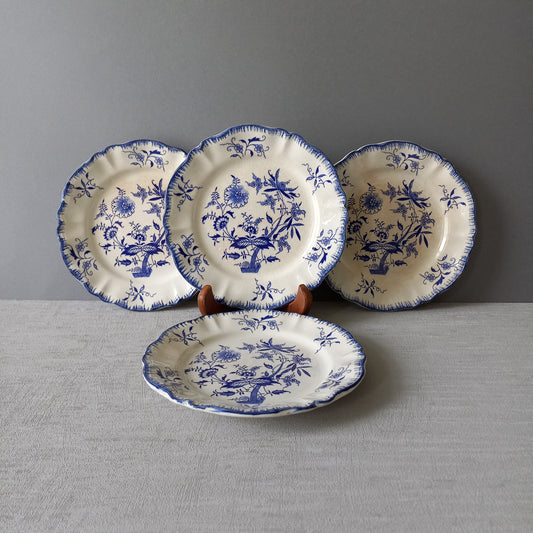 A stunning set of 4 small antique white ironstone plates with blue floral patterns from France.