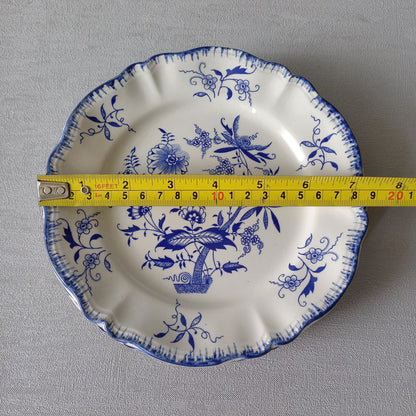 A stunning set of 4 small antique white ironstone plates with blue floral patterns from France.