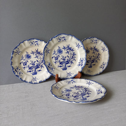 A stunning set of 4 small antique white ironstone plates with blue floral patterns from France.