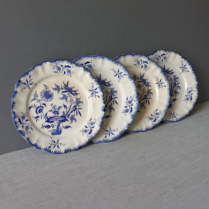 A stunning set of 4 small antique white ironstone plates with blue floral patterns from France.