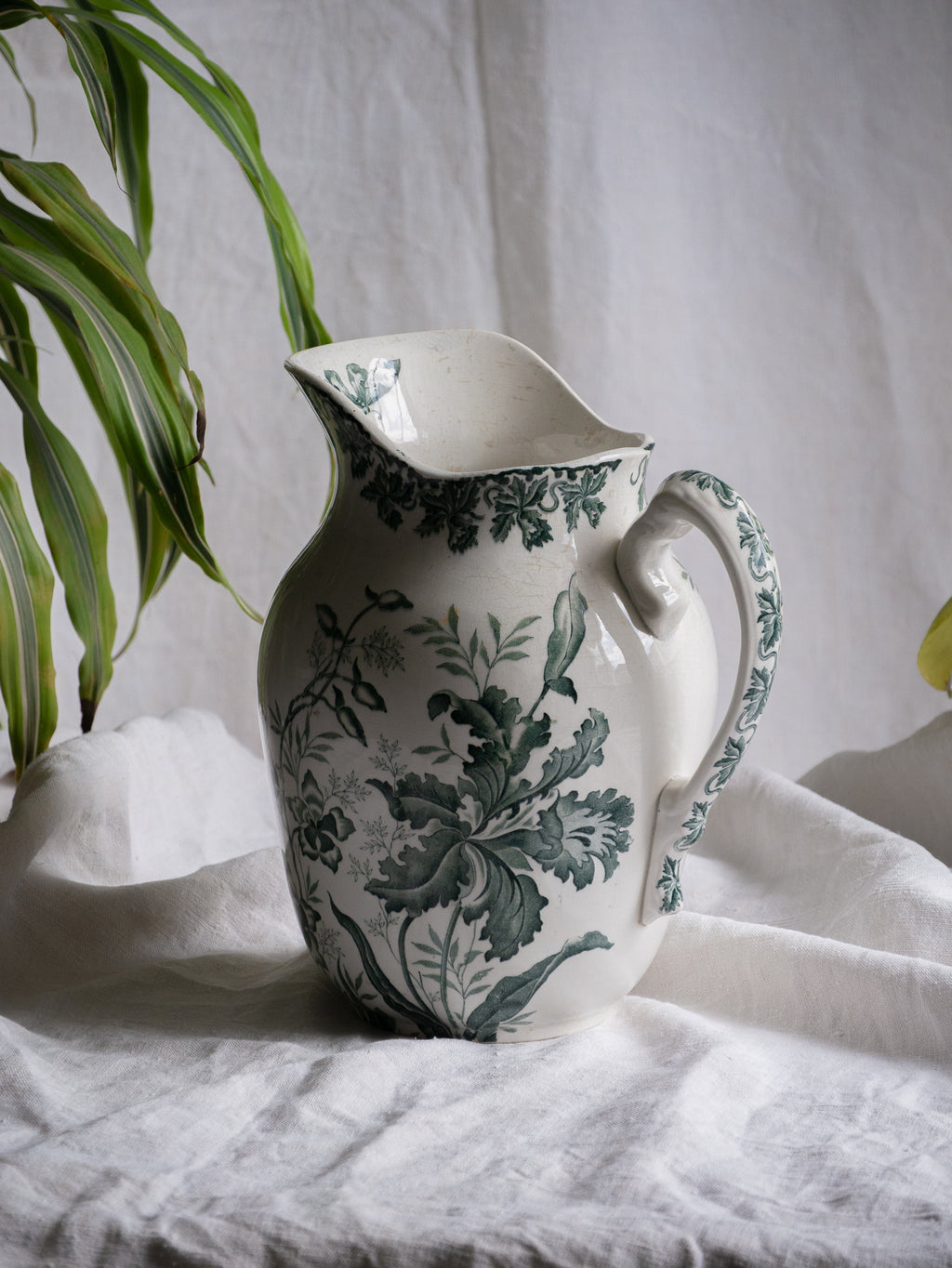 A French antique ironstone jug, basin and soap dish, printed in a soft teal-green bird-and-floral pattern. 