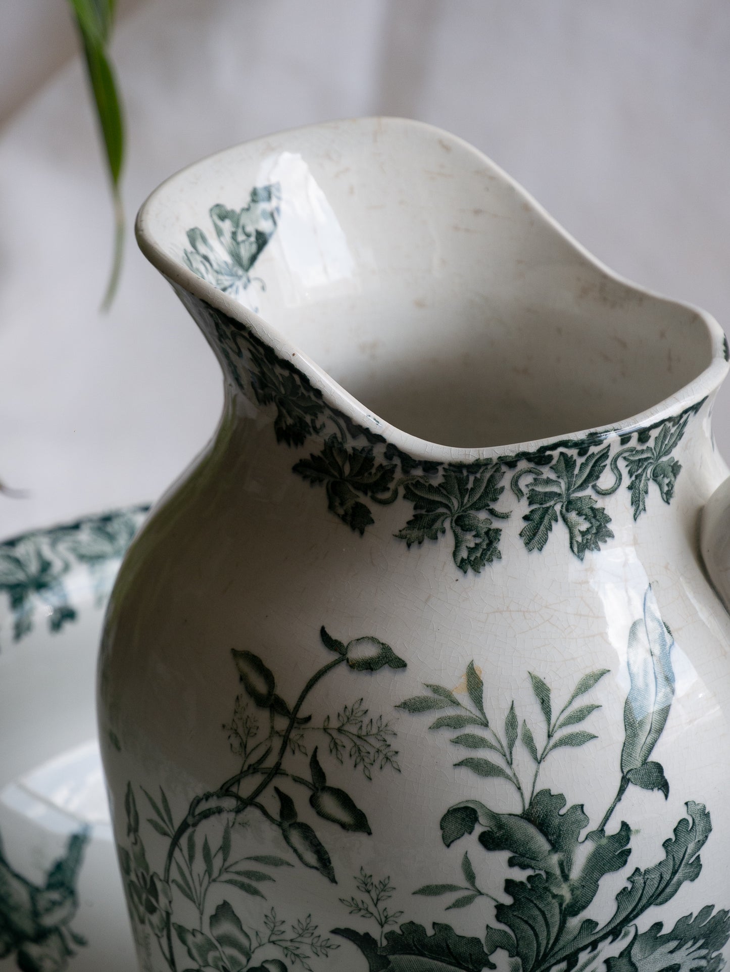 A French antique ironstone jug, basin and soap dish, printed in a soft teal-green bird-and-floral pattern. 
