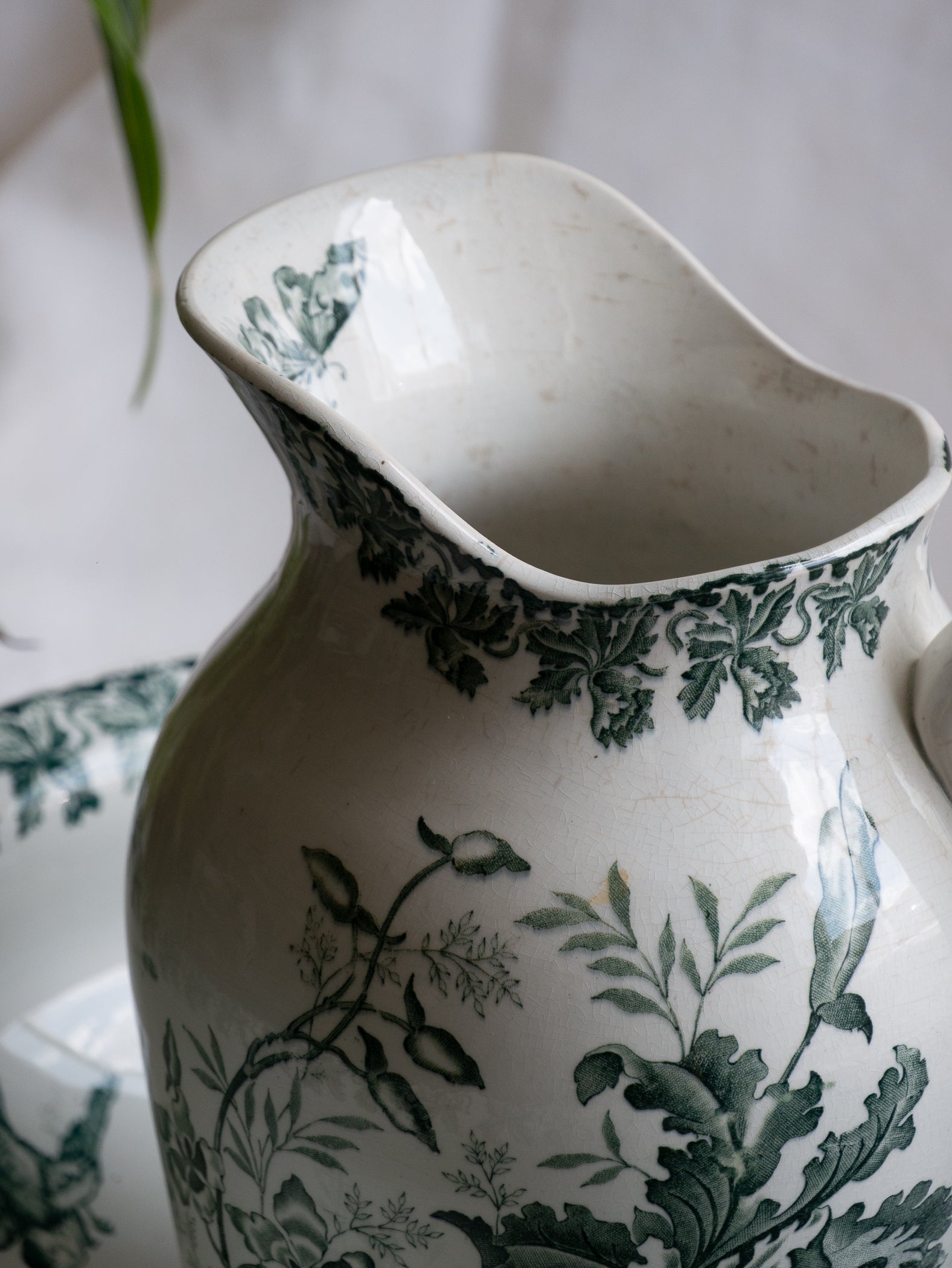 A French antique ironstone jug, basin and soap dish, printed in a soft teal-green bird-and-floral pattern. 