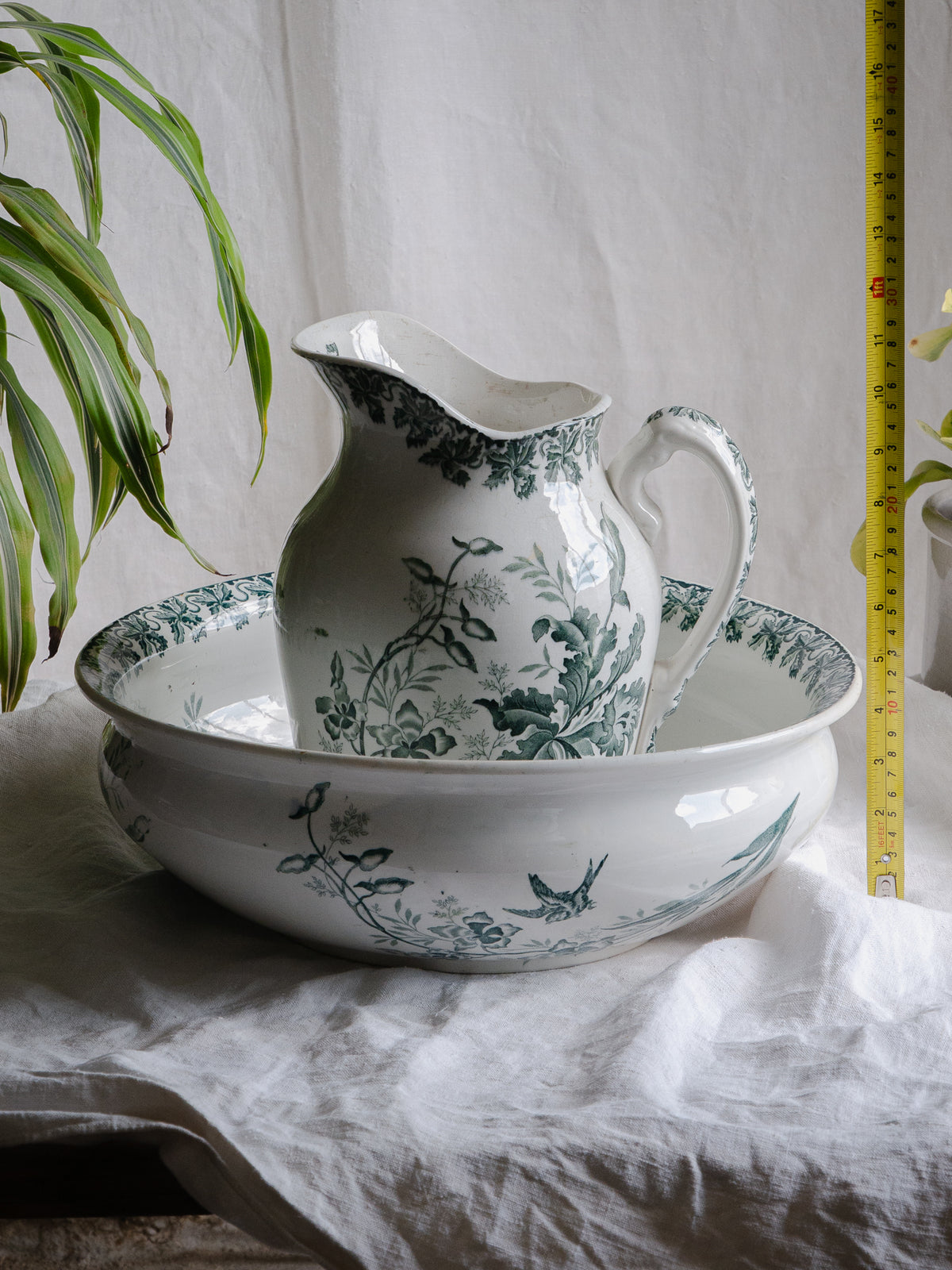 A French antique ironstone jug, basin and soap dish, printed in a soft teal-green bird-and-floral pattern. 