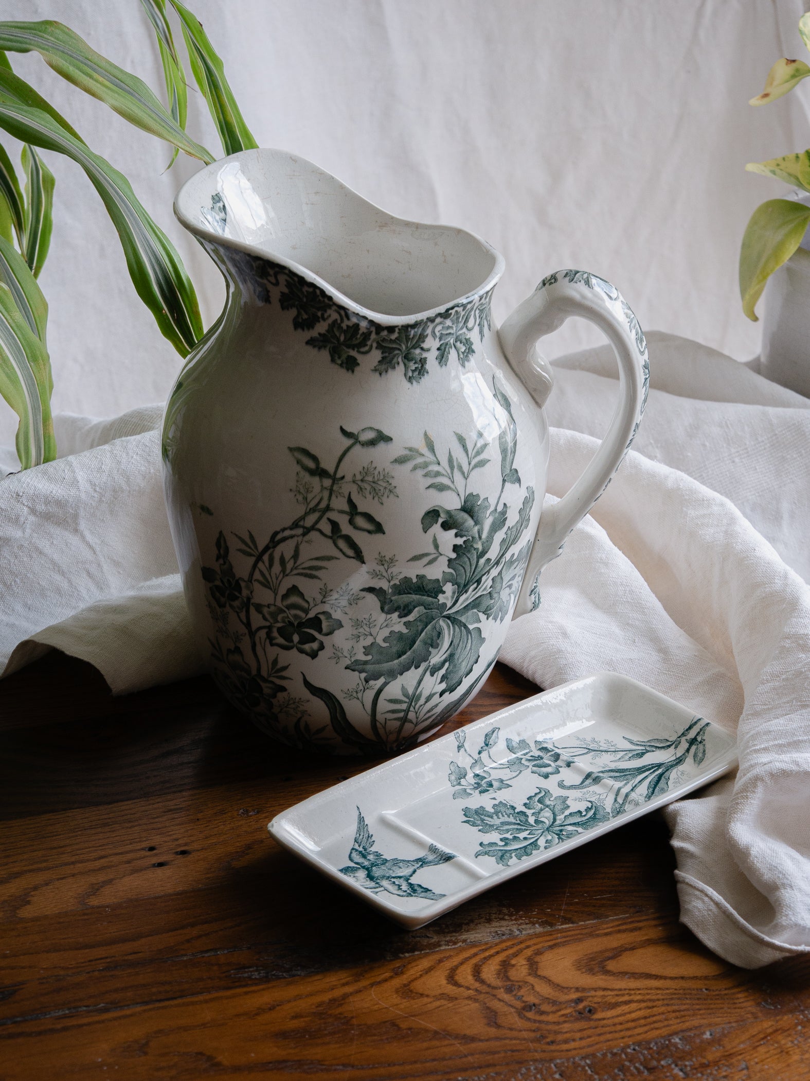 A French antique ironstone jug, basin and soap dish, printed in a soft teal-green bird-and-floral pattern. 