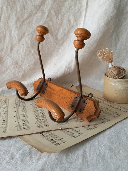 Wooden coat rack on sheet music with a white fabric background