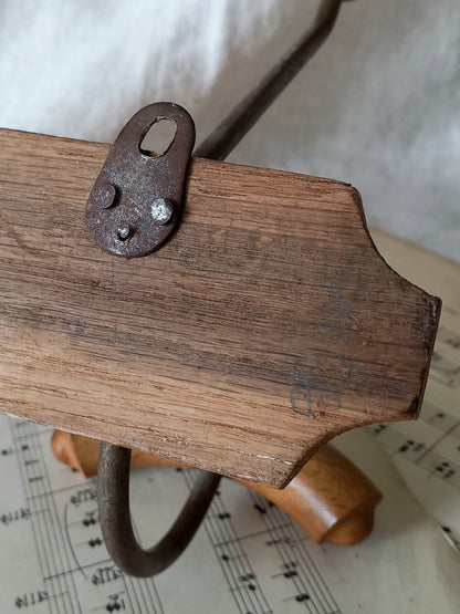 Rear of French vintage coat and hat rack with 2 metal hooks, each hook having wooden pegs for a hat and a coat.
