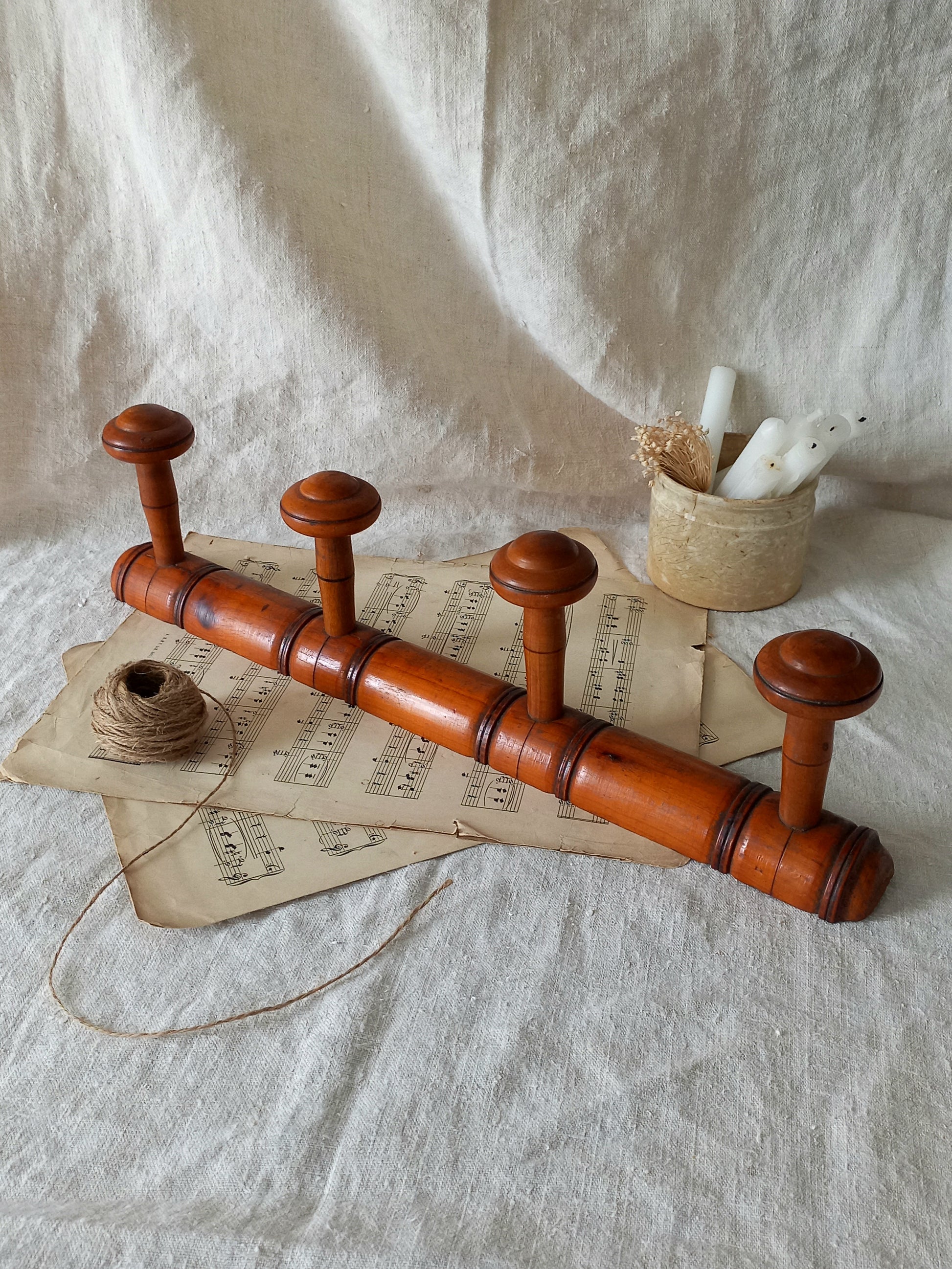 French Antique Faux Bamboo Coat Rack with Four Pegs in rustic setting.