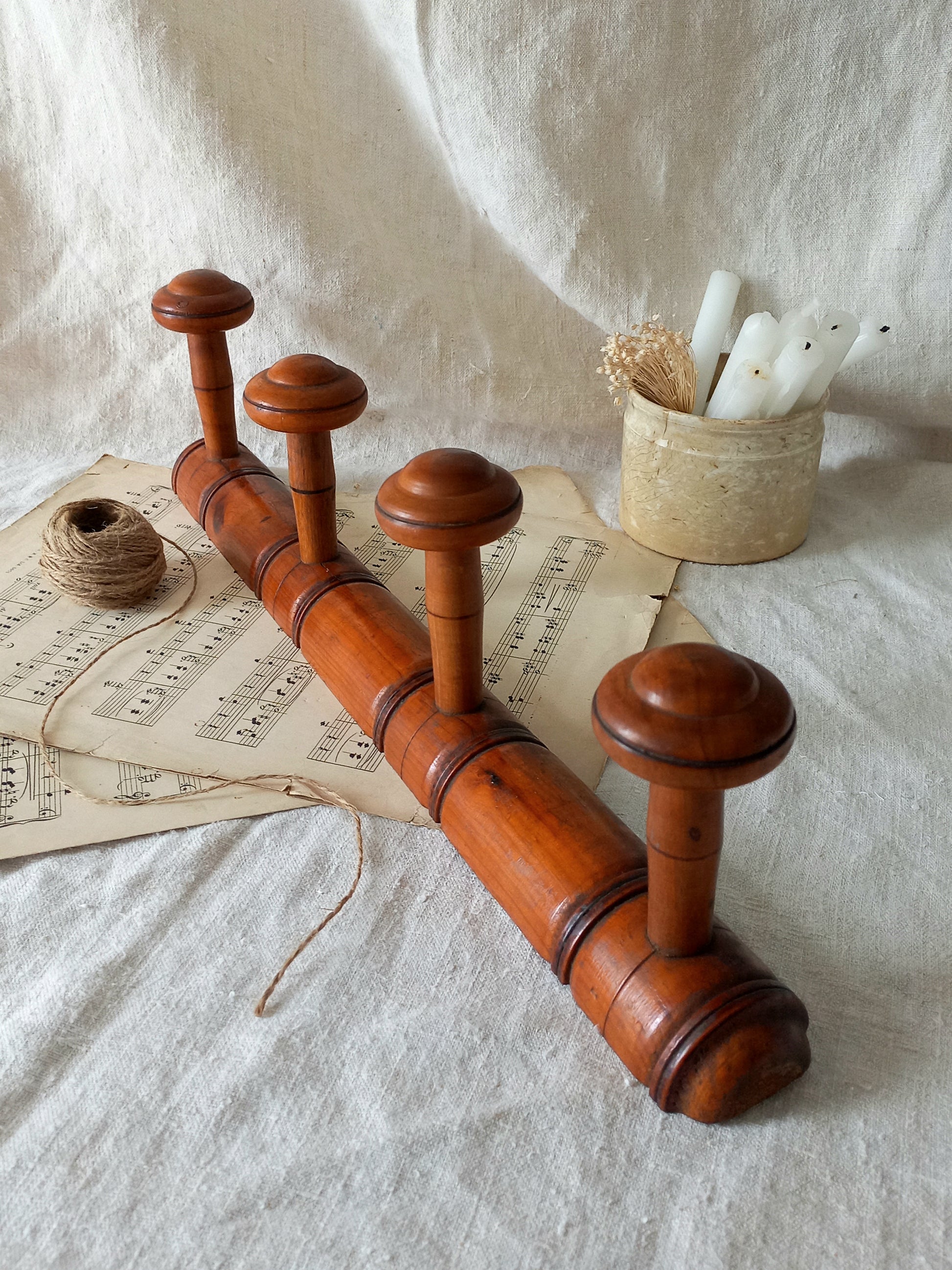 French Antique Faux Bamboo Coat Rack with Four Pegs in rustic setting.