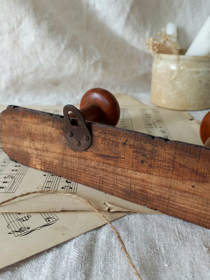 Rear of French Antique Faux Bamboo Coat Rack with Four Pegs in rustic setting.