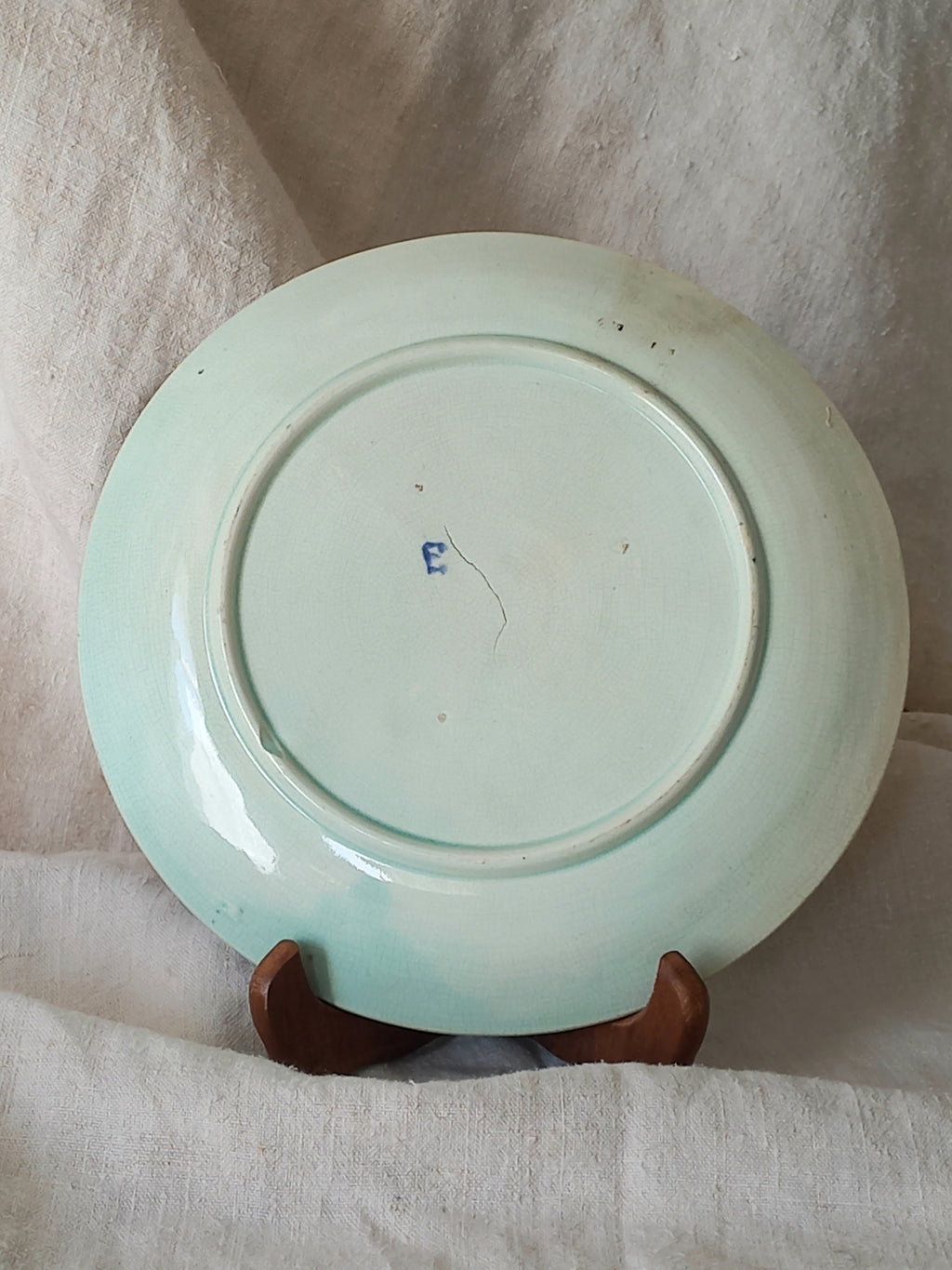 Rear of antique Wasmuel blue floral majolica plate with designs in relief.