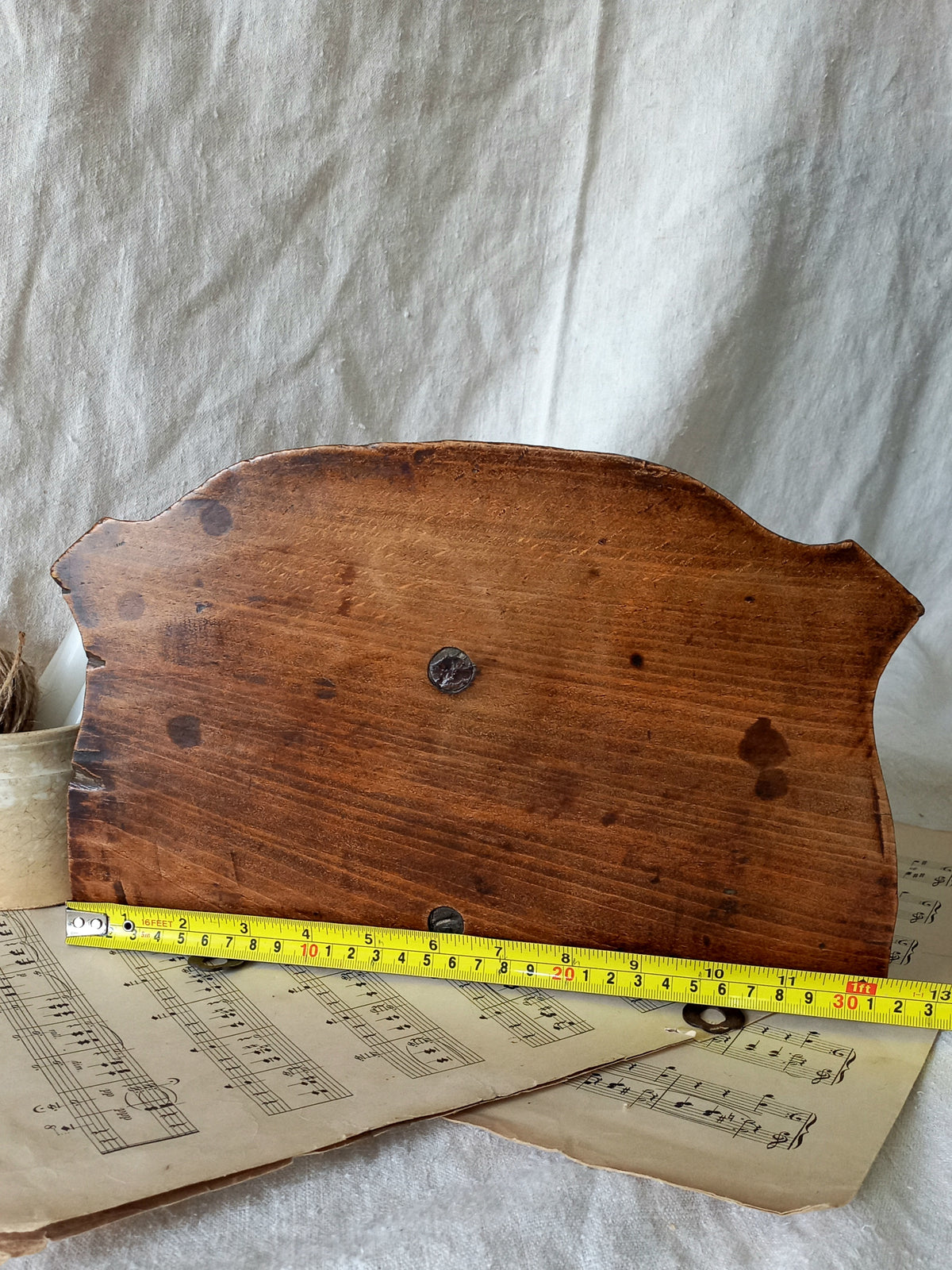 French vintage/antique decorative carved wooden wall mounted shelf with tape measure for reference.
