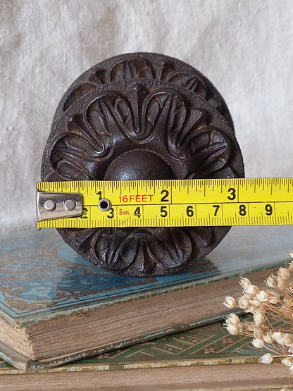 French antique decorative cast iron door pull with tape measure for reference.