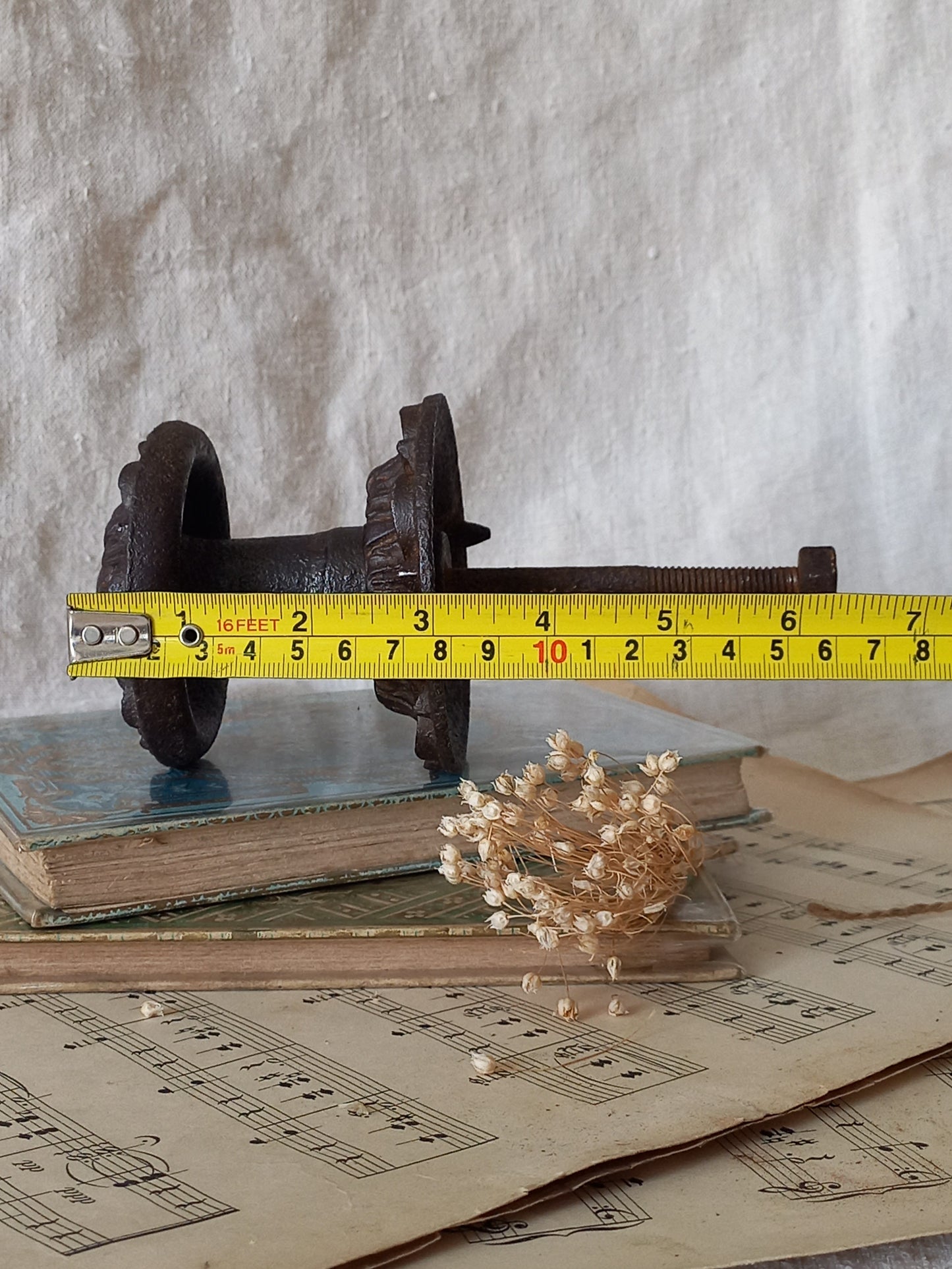 French antique decorative cast iron door pull with tape measure for reference.