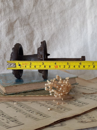 French antique decorative cast iron door pull with tape measure for reference.