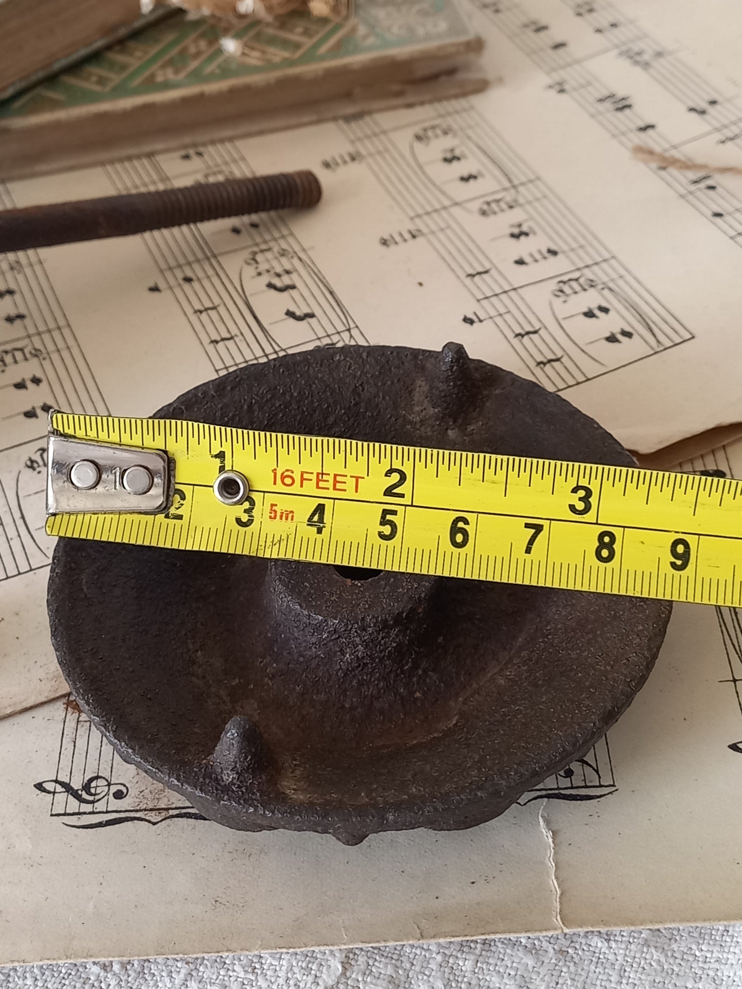 French antique decorative cast iron door pull with tape measure for reference.