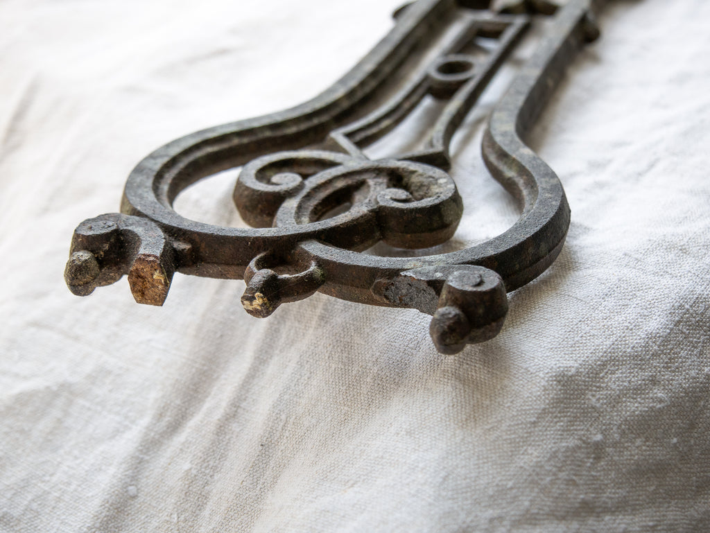 A large French antique crucifix in cast or wrought iron, featuring a figure of the Madonna at its center. Likely once part of a larger architectural structure, this rare piece carries visible signs of age and long exposure to the elements.