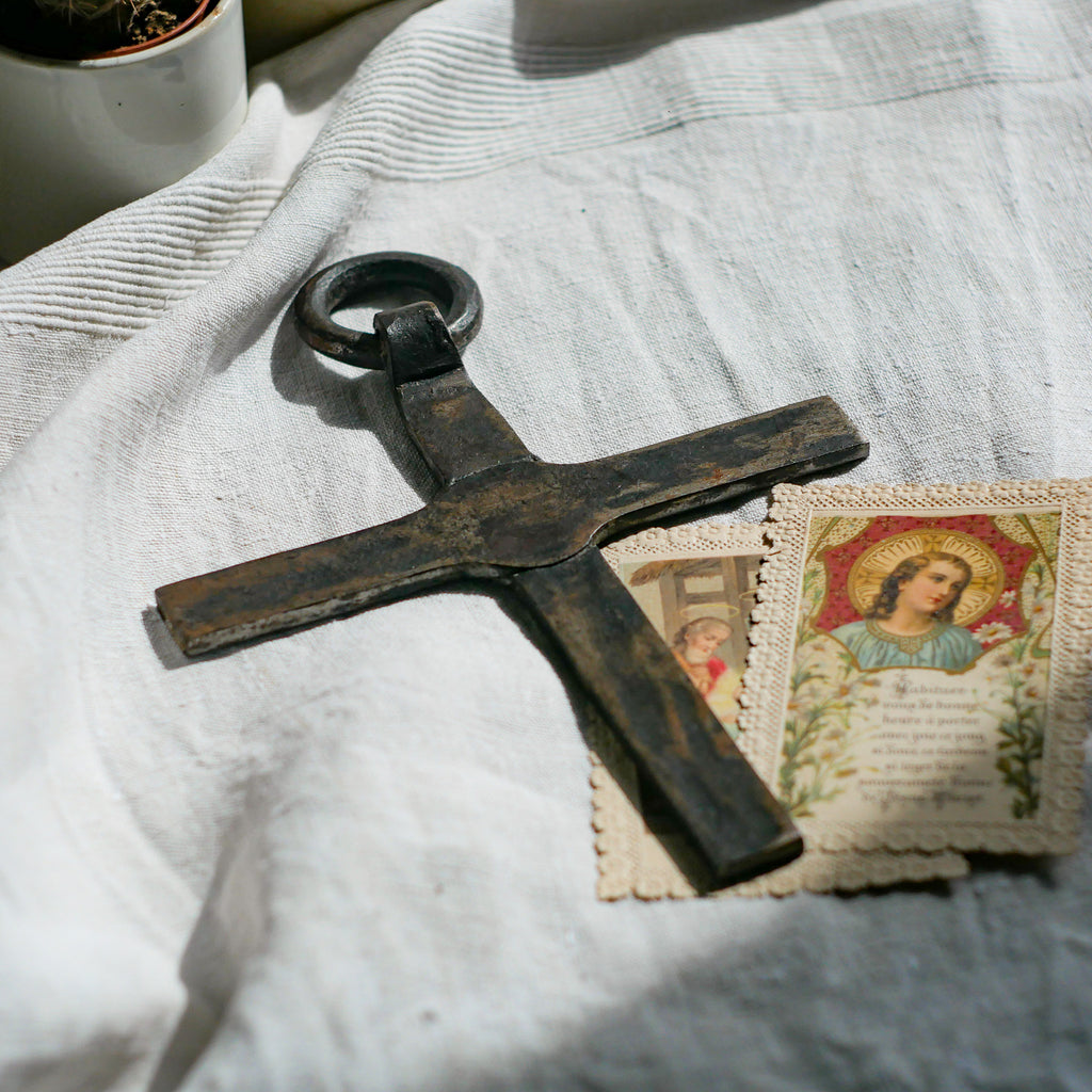 An interesting French antique artisan made Crucifix made from iron and painted black. On one side the metal has worn away in places giving this piece a pleasing patina of age. There's a hanging loop so it's ready to hang in your home.

We guesstimate this piece to be over 100 years old.