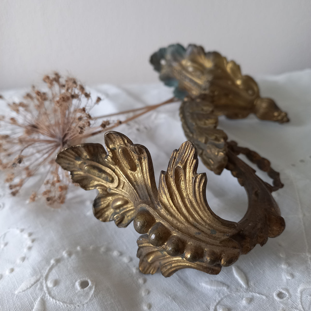 Decorative gold leaf design on a textured white surface