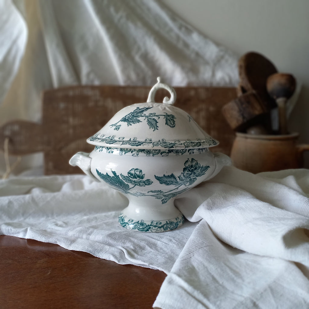 A small-sized antique ironstone soup tureen by French manufacturer, St. Amand. This tureen is adorned with a beautiful teal coloured floral transferware pattern and has a splendid little handle on the lid. In summary, an elegant piece with just enough patina of age to give it character.
