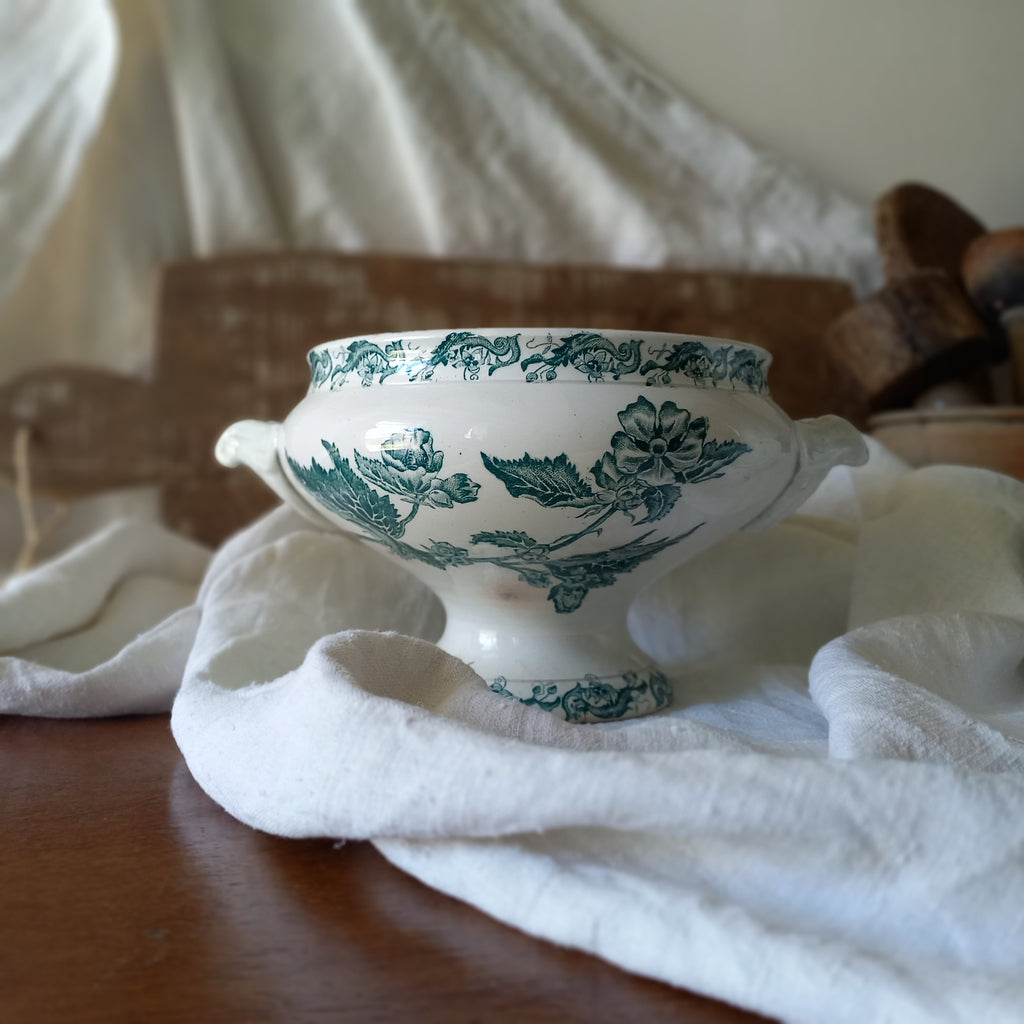 A small-sized antique ironstone soup tureen by French manufacturer, St. Amand. This tureen is adorned with a beautiful teal coloured floral transferware pattern and has a splendid little handle on the lid. In summary, an elegant piece with just enough patina of age to give it character.