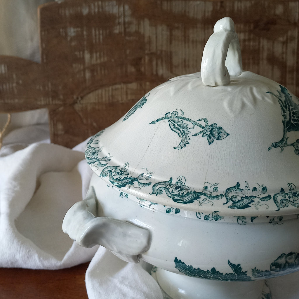A small-sized antique ironstone soup tureen by French manufacturer, St. Amand. This tureen is adorned with a beautiful teal coloured floral transferware pattern and has a splendid little handle on the lid. In summary, an elegant piece with just enough patina of age to give it character.