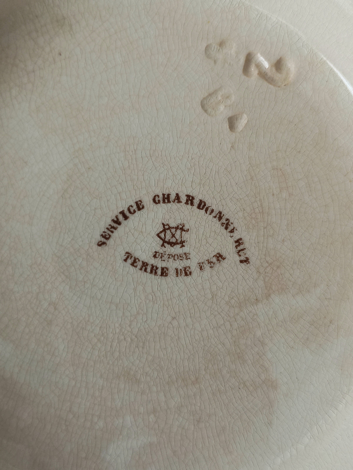 Close up of underneath of a French antique ironstone/earthenware bowl with sepia/brown bird pattern