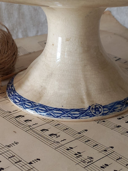 Close-up of a beautiful French antique footed dish/cake stand with a striking dark blue floral pattern made by premier manufacturer Sarreguemines.
