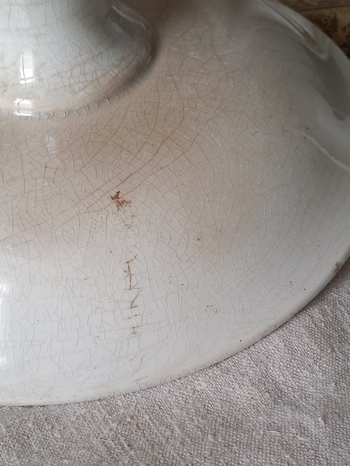 Close-up of a French antique ironstone/earthenware white patinated footed-dish with a pretty burgandy colour floral pattern